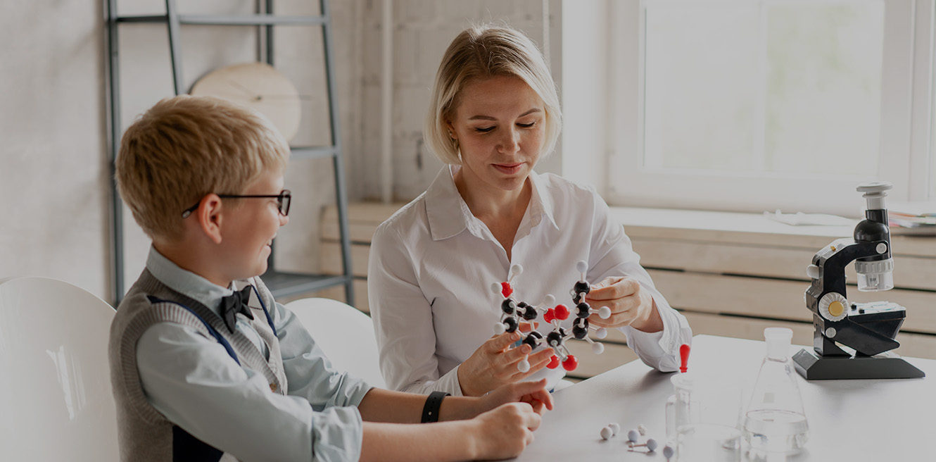 Female science tutor in Cleveland studying chemistry with student